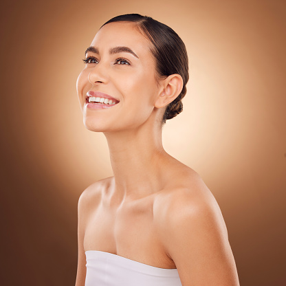 Studio face, happy and beauty woman with luxury facial cosmetics, natural makeup and skincare glow. Dermatology healthcare satisfaction, spa salon person or aesthetic female model on brown background