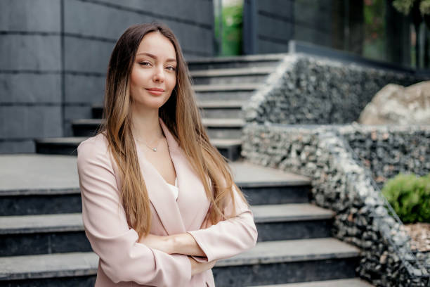 istock female boss with folded hands on the background of an office building 1496613304