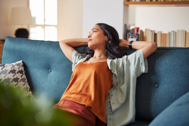 istock Pensive woman at home while looking up 1496613436