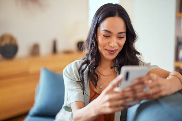 istock Happy mixed race woman using phone with new app 1496613561