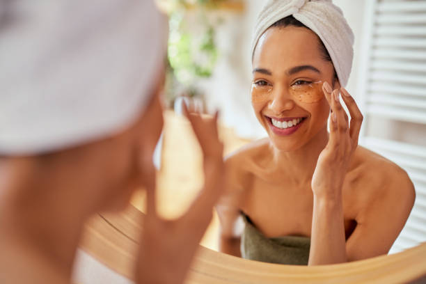 istock Woman applying eye mask on dark circles 1496614963