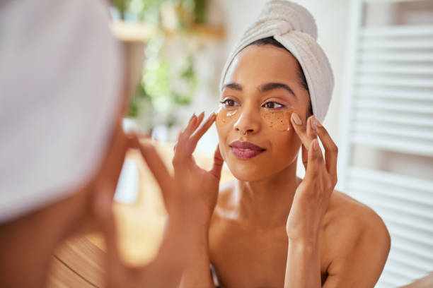 istock Young mixed race woman applying eye patches in bathroom 1496614970