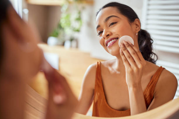 Latin beautiful woman using cotton pads for cleaning face stock photo