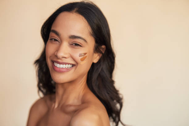 istock Multiethnic woman trying different tones of liquid foundation on face 1496615335