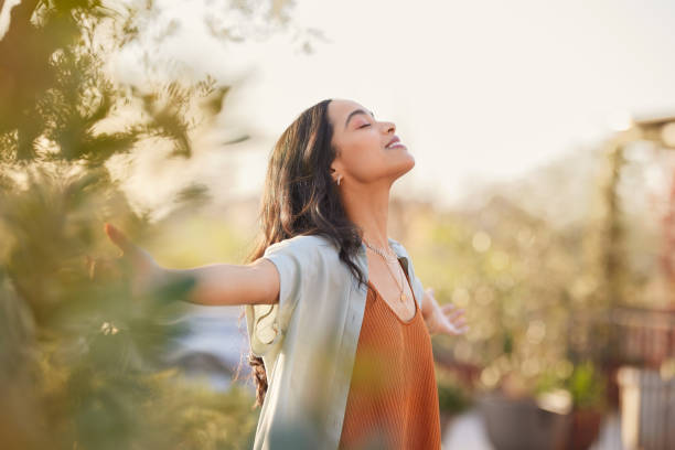 serene latin woman enjoy sunset with gratitude - wellness stockfoto's en -beelden