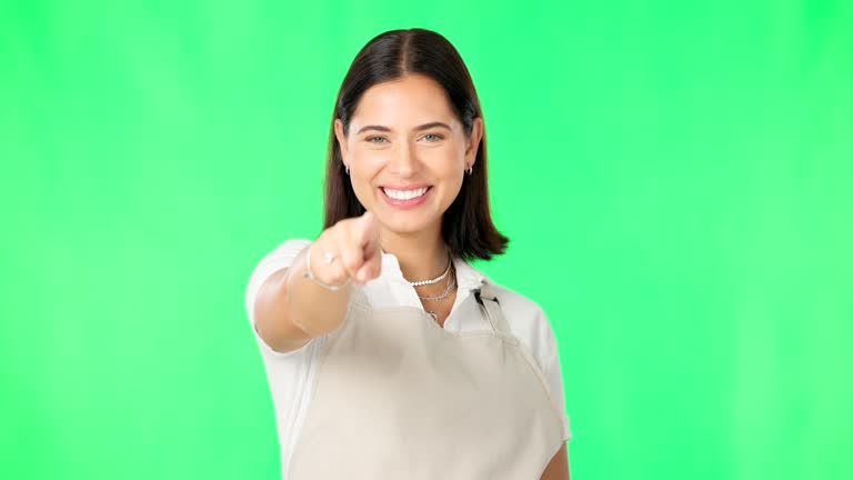 You, green screen and woman pointing for promotion or promo with a smile and isolated in a studio background. Deal, sale and portrait of female barista or cafe owner advertising and marketing