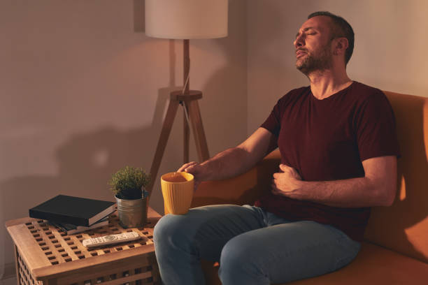 istock Man at home suffering from stomach pain. 1496619948