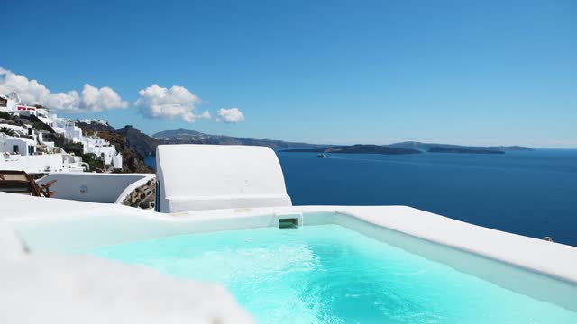 Santorini island, Greece. Luxury swimming pool with sea view.