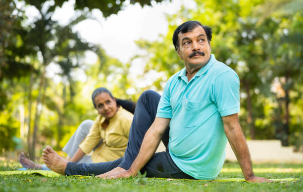 istock Indian elderly senior people at park doing stretching exercise or yoga asana - concept of active healthy lifestyle, morning routine and wellbeing 1496624862