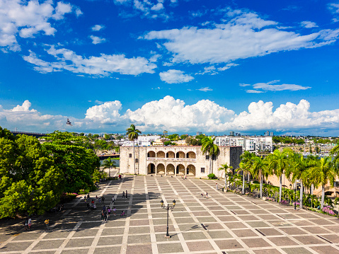 Alcazar de Colon, Diego Columbus residence on Spanish Square. Tourists walk in Colonial Zone of the city Santo Domingo, Dominican Republic. High quality photo