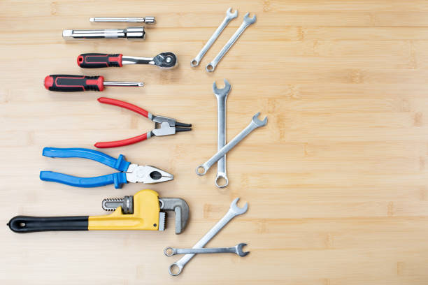 istock A set of working tools, a hammer, a screwdriver, adjustable spanner, sockets for repair on a bamboo, wooden background 1496630857