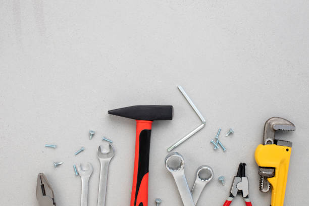 istock A set of working tools, a hammer, a screwdriver, adjustable spanner, sockets for repair on a gray concrete background 1496630864