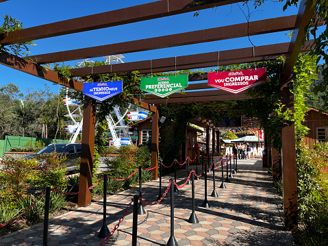 Wooden fabulous rounded gates in medieval style in an amusement park on sunny day.