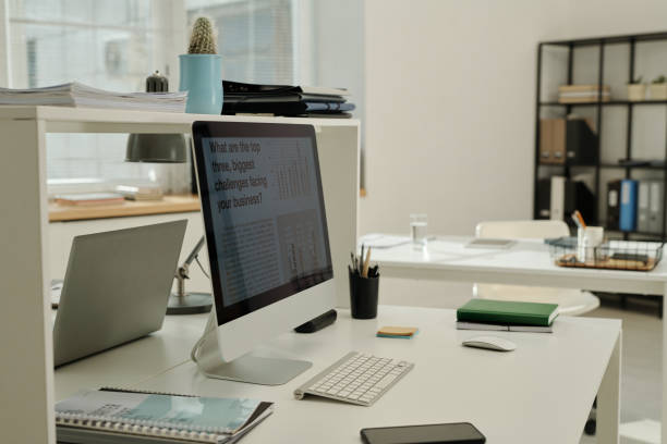istock Workplace of white collar worker with computer monitor on desk 1496638020