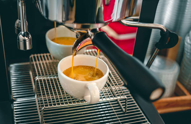 istock Espresso coffee extraction from a professional coffee machine with a bottomless filter, Close-up of a coffee drop  from the coffee machine 1496638034