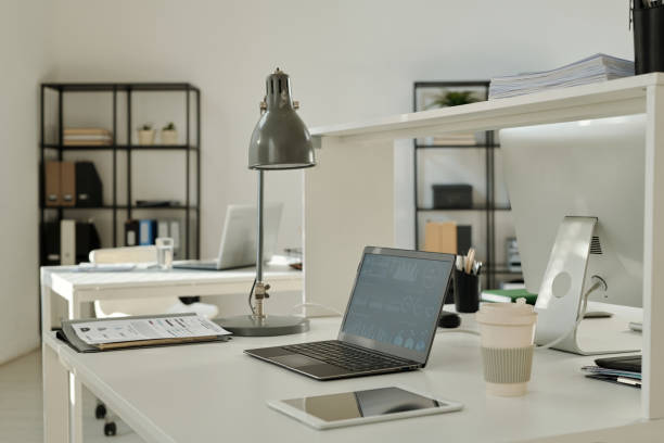 istock Financial graphic data on screen of laptop standing on desk in office 1496638038