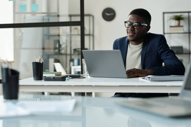 istock Young African American manager in suit communicating in video chat 1496638693
