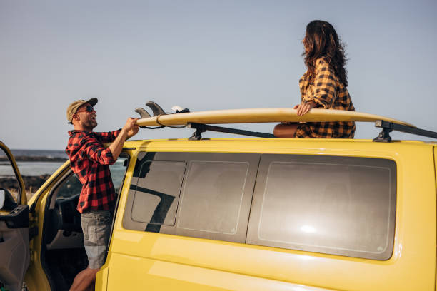 istock Couple at the beach with their van going surfing 1496639434