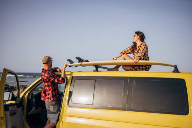 istock Couple at the beach with their van going surfing 1496639597