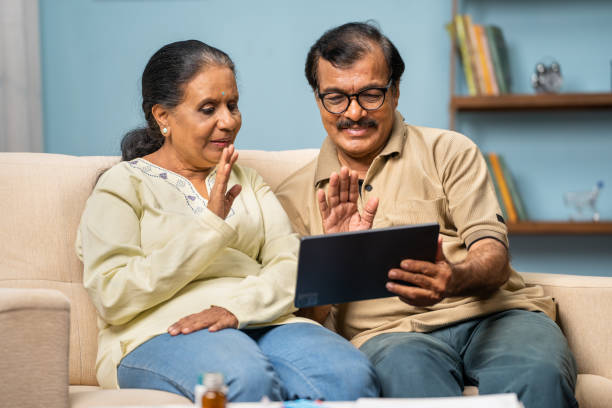 istock Indian senior couple talking with doctor on video call using digital tablet at home - concept of online consultation, medicare and home health care 1496640868