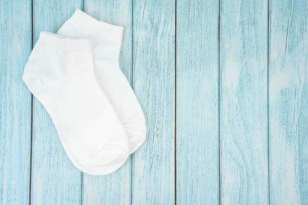 istock A White cotton socks for design on blue wooden background. 1496641680