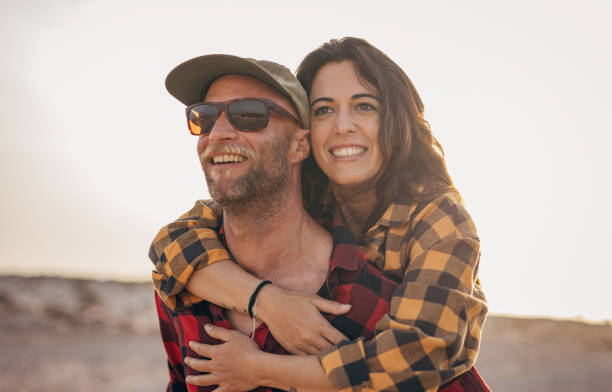 istock Couple in love having fun on the beach during the sunset 1496642117