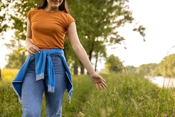 istock Young woman enjoying a walk in the woods 1496643565