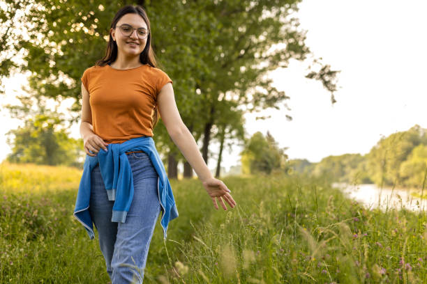 istock Young woman enjoying a walk in the woods 1496643588