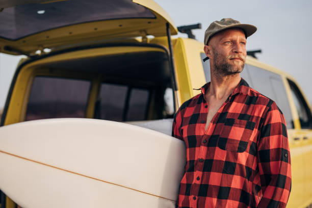 istock Man surfing on the beach 1496643598