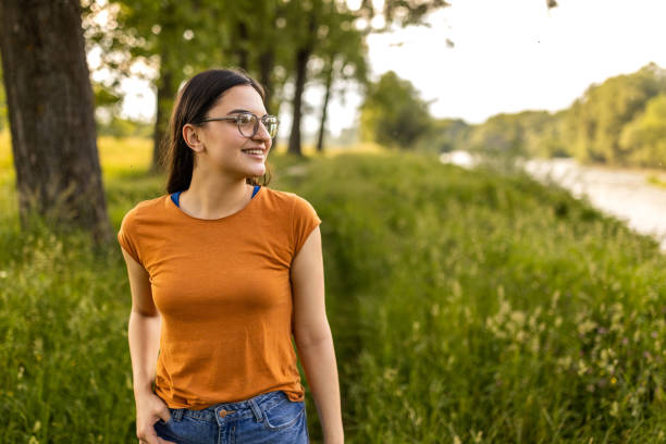 istock Young woman enjoying a walk in the woods 1496643717