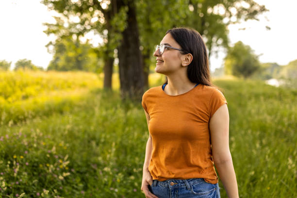 istock Young woman enjoying a walk in the woods 1496643903