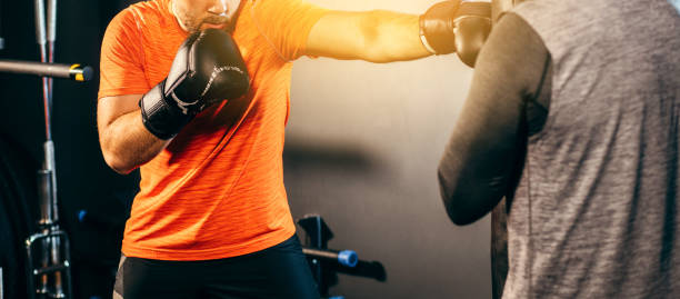 Adult men boxer training in gym