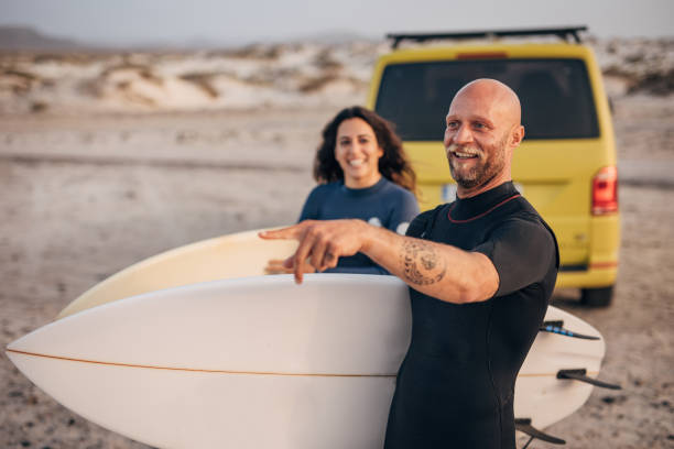 istock A couple with surf boards going surfing on the beach 1496646140