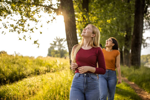 Two young Caucasian women walking together in the forest