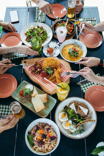 istock Group of people eating and drinking in cafe 1496647096