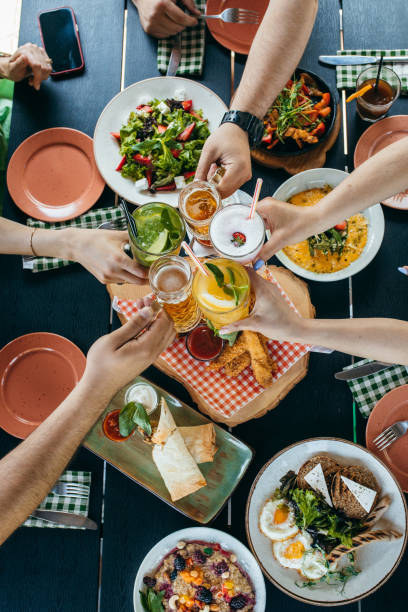 istock Group of people eating and drinking in cafe 1496647188