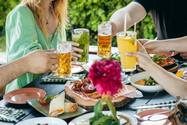 istock Group of people eating and drinking in cafe 1496647213