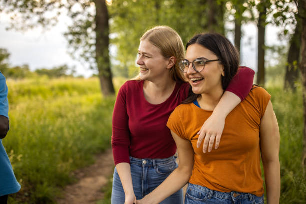 istock Two female friends embracing in the woods 1496647552
