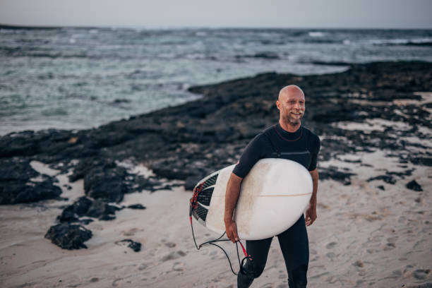 istock Man surfing on the beach 1496648515
