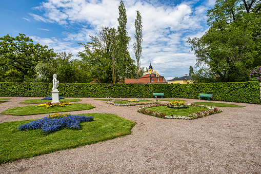 Weimar, Germany - May 12, 2023: Russian garden in Castle Belvedere near Weimar Thuringia Germany. It is a elegant summer residence dating from 18th century. View from the Castle park.