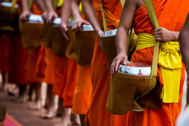istock Group of Monks doing Morning Alms 1496653357