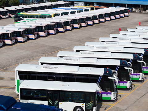 Schiphol Airport, Amsterdam, The Netherlands - April 25, 2018: Electric buses charging energy at Amsterdam Schiphol Airport, the Netherlands, as part of sustainable public transport program