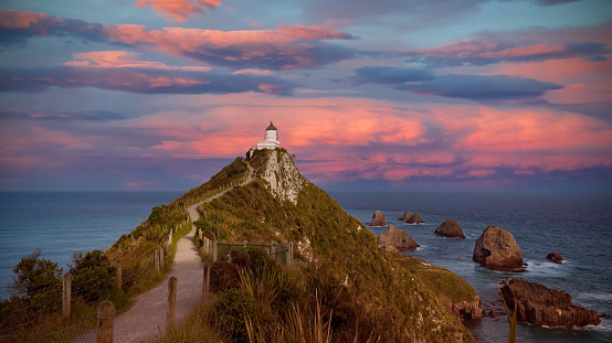 Landscape view with sunset scene of the Catlins, Nugget Point Lighthouse, South Island, New Zealand