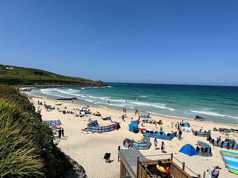 Crowds of holiday makers, day travellers and tourists enjoying the summer sunny day on the popular beach in St. Ives, Cornwall, England, UK. Holidays by the Atlantic Ocean