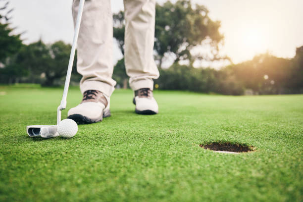 istock Golf, closeup and golfer or player hit ball and professional athlete training and putting on a filed as exercise or workout. Feet, equipment and gentleman or person relax and playing a sport 1496658541