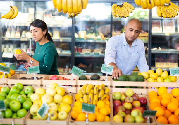 istock Married couple choosing fruits in store 1496659665