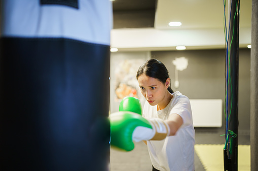 Young woman boxing exercises with her trainer