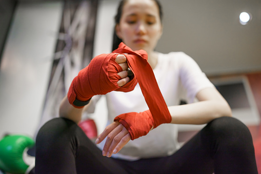 Young woman boxing exercises with her trainer