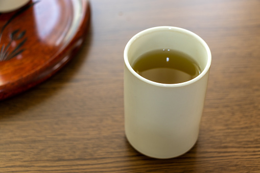 white cup with green tea