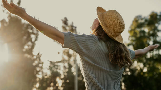 istock Woman with head back and arms outstretched in nature 1496662206